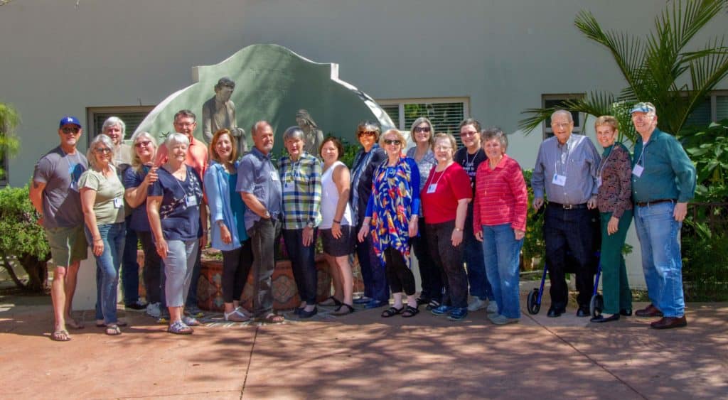 Photo of 19 members of the First Pres community outside of the waterfall in the Serra Retreat Center Courtyard